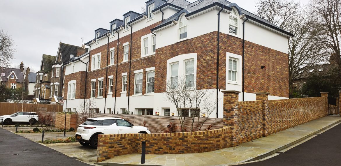 Completed Silver Birches residential scheme in Richmond: brick townhouses with mansard roofs