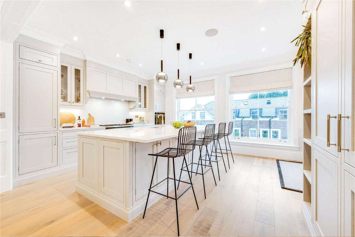Contemporary kitchen with island and bar stools in a new build home at Silver Birches, Richmond